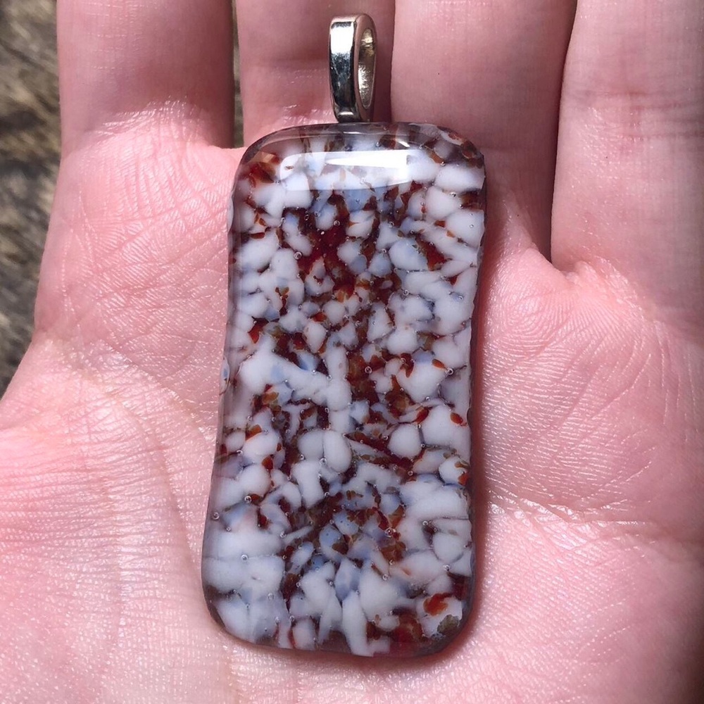 Red and white blown glass pendant with silver toned bail